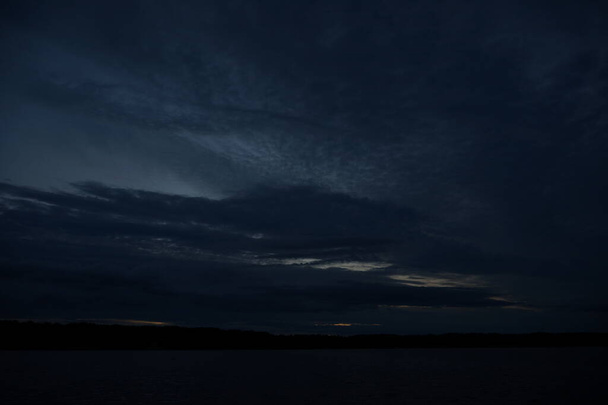 vista pittoresca del cielo buio infinito sul lago di prima mattina
    - Foto, immagini
