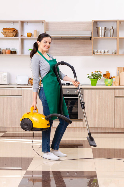 Young female contractor doing housework - Fotoğraf, Görsel