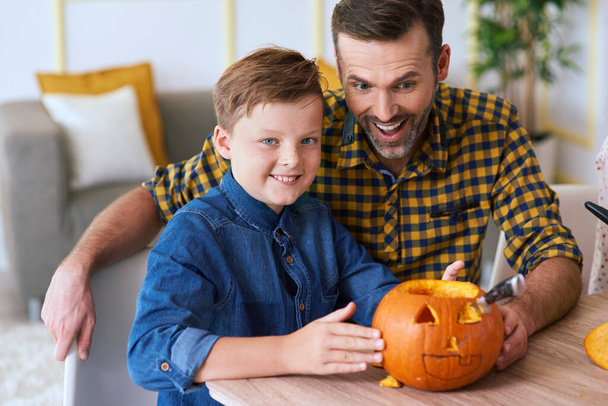 Boy and father carving pumpkin  - Фото, зображення