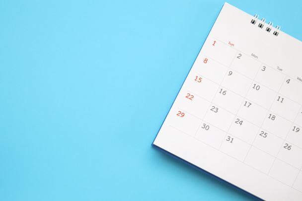 calendar page close up on blue background business planning appointment meeting concept - 写真・画像