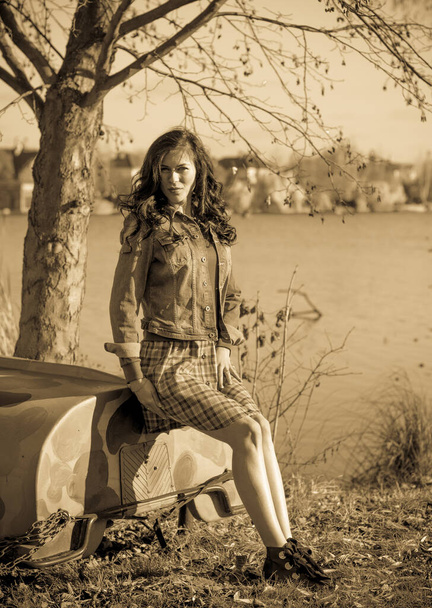 Autumn fashionable ideas. Woman in jeans jacket and plaid  dress . Modern fashion - Photo, Image