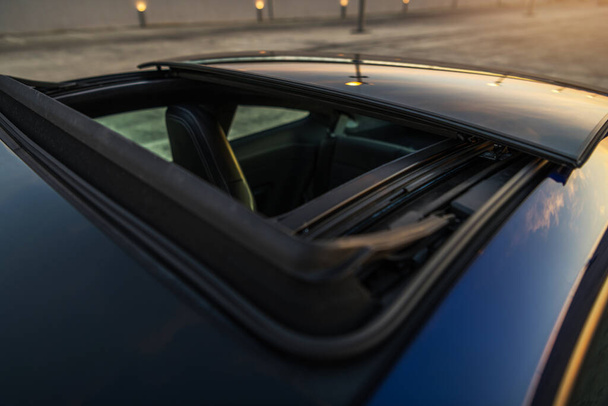 Exotische luxe sportwagen met groot open automatisch glazen zonnedak.  - Foto, afbeelding