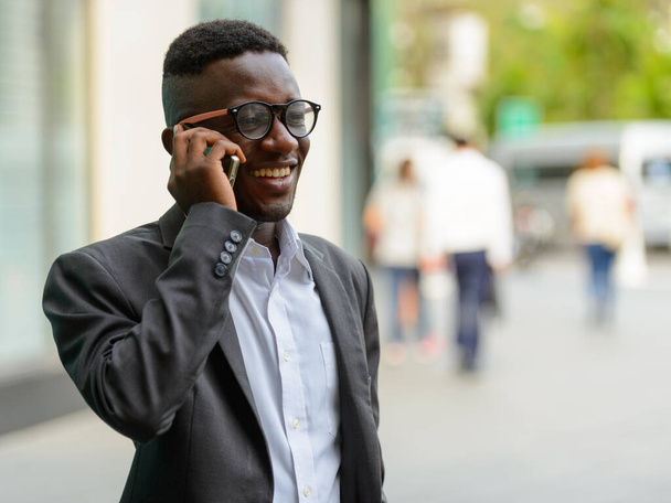 Portrait of young African businessman in the city outdoors - Photo, Image