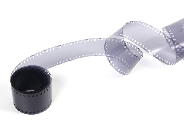 35mm film strip in white background, copy space cinema word with place for text,  film strip for festival, brochure, poster, banner or flyer. Film entertainment concept. - Photo, Image