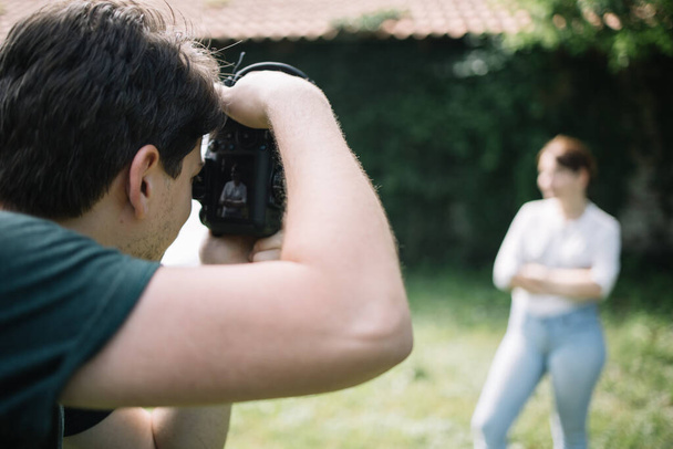 Close-up view of man photographing blurred woman outdoor - Foto, Bild