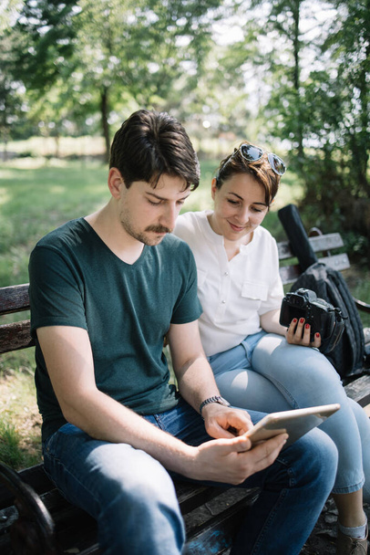 Portrait of woman and male photographer looking at tablet - Foto, Imagen