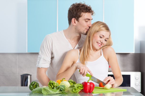 Young beautiful couple cooking at home - Photo, Image