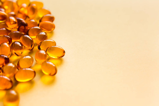Fish oil capsules on beige background, Omega 3. Vitamin D. Concept of healthy lifestyle. Selective focus. - Fotografie, Obrázek