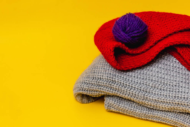part of a knitted grey sweater on a yellow background - Valokuva, kuva