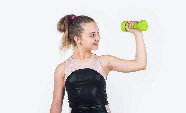 show strength. small girl training with barbells. sport and fitness. teen girl hold dumbbell. sportswear equipment shop. healthy lifestyle. dieting for kids. child workout in gym isolated on white - 写真・画像