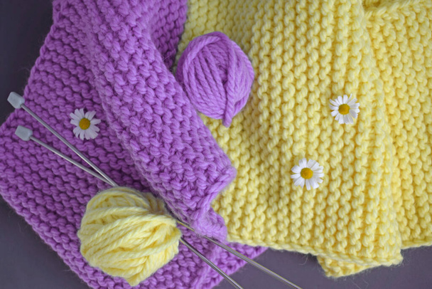 A warm lilac-yellow scarf, knitted with thick yarn.Handmade work. - Фото, изображение