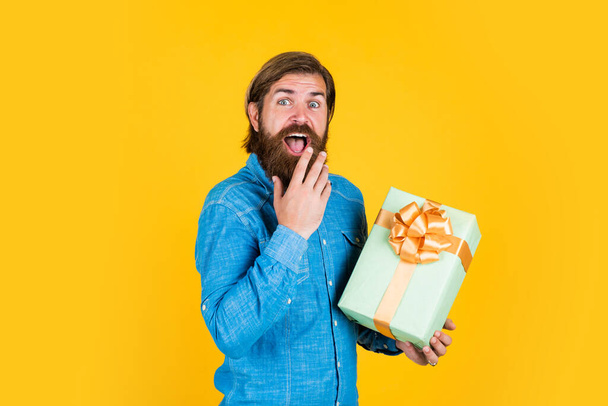 making purchases at store. buy anniversary gifts. surprised male open box with something exciting inside. mature man looking casual in surprise with present gift box. commonly used for birthday - Zdjęcie, obraz