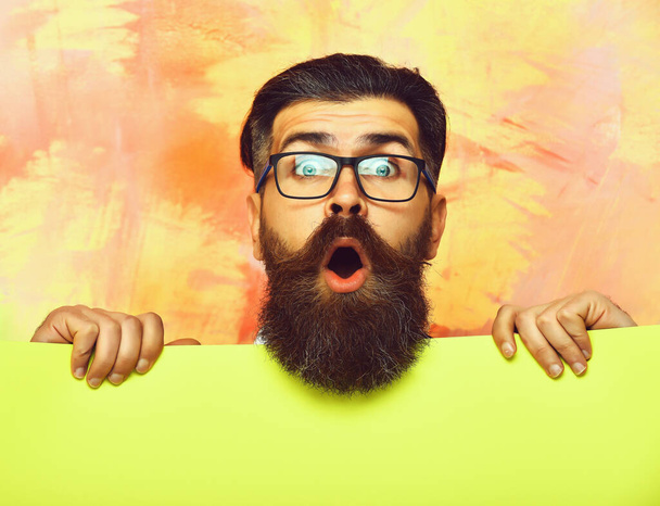bearded man with surprised face in glasses on colorful background - Foto, immagini