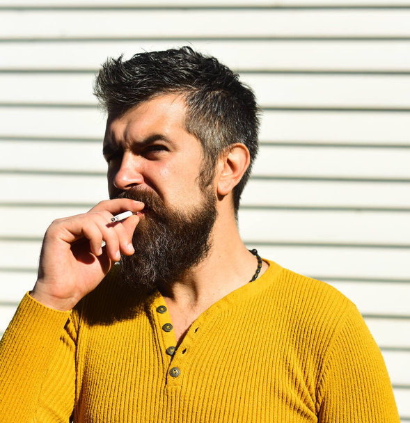 Bad habit and unhealthy lifestyle concept. Guy with beard smokes - Fotografie, Obrázek