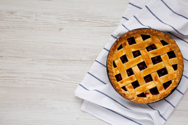 Yummy Homemade Cherry Pie on a white wooden table, top view. Flat lay, overhead, from above. Space for text. - Foto, afbeelding