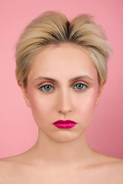 girl with short hair on  pink background, big Blue eyes , bright pink lipstick on  lips, perfect even skin, beautiful makeup - Photo, image