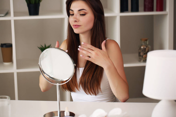 face of young beautiful healthy woman looking in the mirror - Фото, изображение
