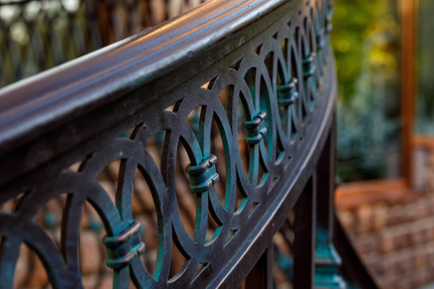 Blurred fragment of forged decorative railing. Close-up - Photo, Image