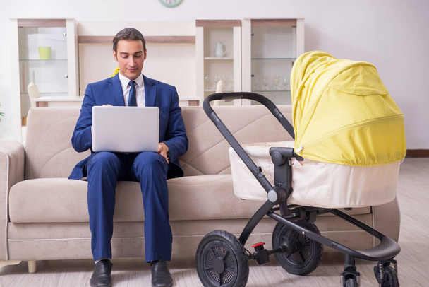 Young businessman looking after baby - Photo, Image