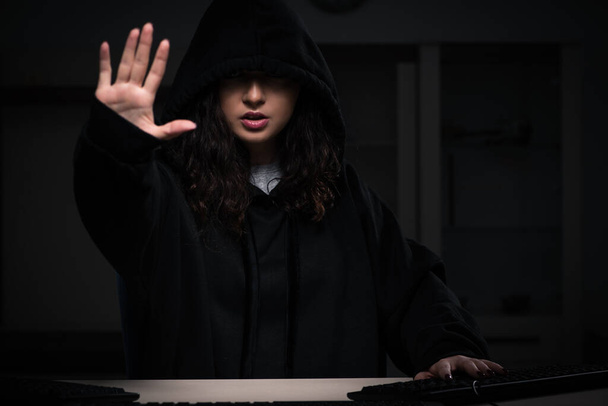 Female hacker hacking security firewall late in office - Foto, afbeelding