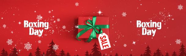 Boxing day banner design. Gift with sale tag on red background - Fotoğraf, Görsel
