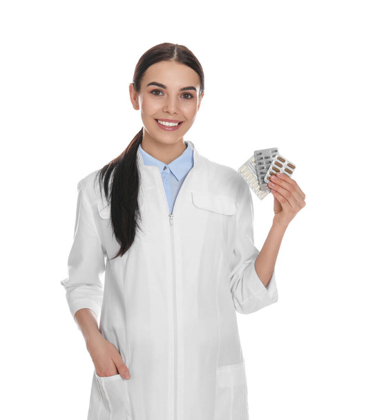 Professional pharmacist with pills on white background - Valokuva, kuva