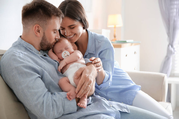 Happy couple with their newborn baby at home - Fotoğraf, Görsel