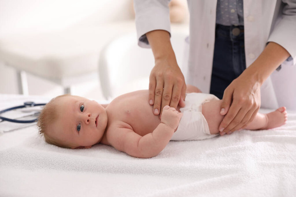 Doctor examining cute baby indoors, closeup. Health care - Фото, зображення