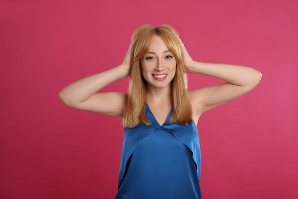 Beautiful young woman with blonde hair on pink background - Φωτογραφία, εικόνα