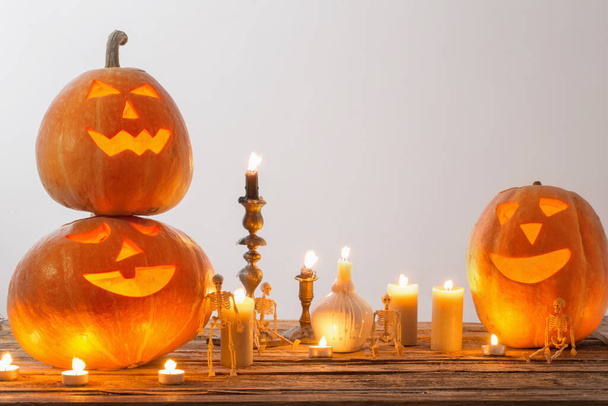 halloween pumpkins with candles on wooden table - Фото, изображение