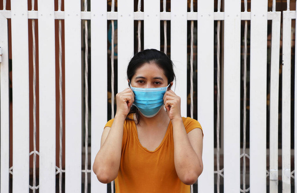 Ασιάτισσα που φοράει μάσκα για την πρόληψη των μικροβίων. Μικροσκοπική προστασία μορίων ή ιών ή Covid 19. Έννοια της καταπολέμησης της ασθένειας. - Φωτογραφία, εικόνα