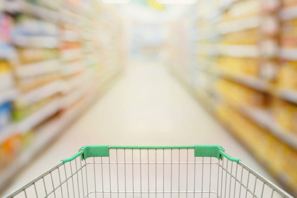 Shopping cart view with Supermarket aisle blurred background - Photo, Image