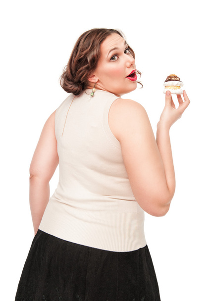Beautiful plus size woman eating pastry - Photo, Image