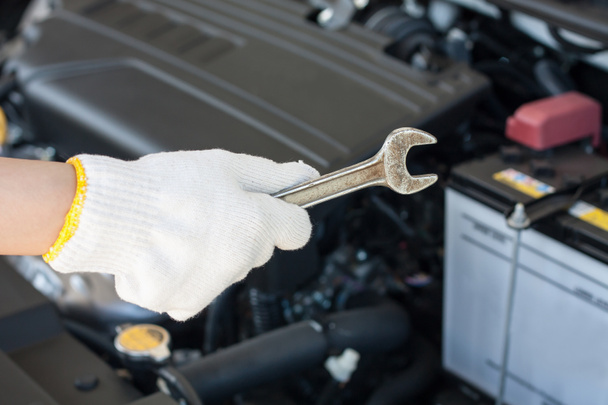 Hand with wrench repairing and checking car engine - Photo, Image