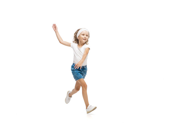 Happy little caucasian girl jumping and running isolated on white background - Fotoğraf, Görsel