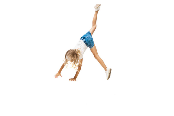 Happy little caucasian girl jumping and running isolated on white background - Fotografie, Obrázek