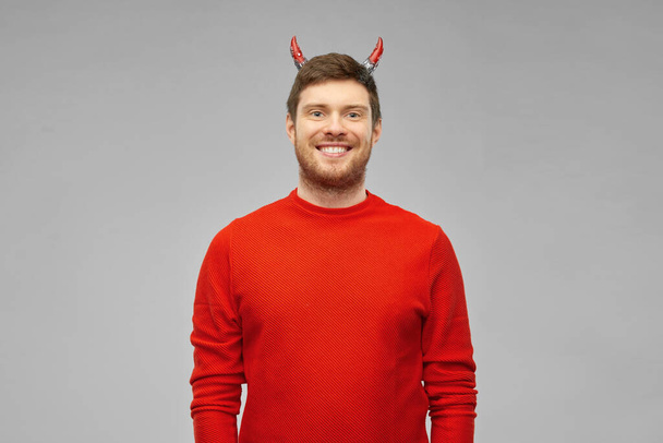 happy man in halloween costume of devil over grey - Zdjęcie, obraz