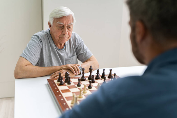 Elderly Senior Playing Chess Table Board Game - Foto, immagini