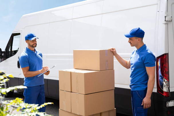 Van Courier And Professional Movers Unload Truck - Valokuva, kuva