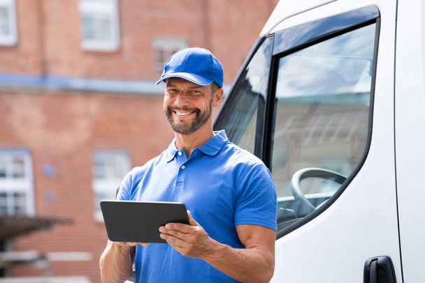 Delivery Man Near Truck Or Van Using Tablet - Фото, изображение