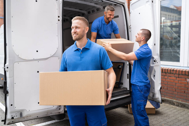 Truck Movers Loading Van Carrying Boxes And Moving House - Foto, imagen
