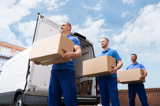 Truck Movers Loading Van Carrying Boxes And Moving House - Photo, Image