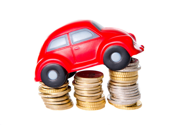 macro of a red toy car on a pile of euro coins - Foto, imagen