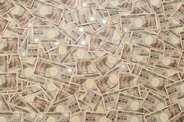 Yen - Ιστορικό με ιαπωνικά χρήματα σε χαρτονομίσματα των δέκα χιλιάδων γιεν. Οριζόντια βολή. - Φωτογραφία, εικόνα