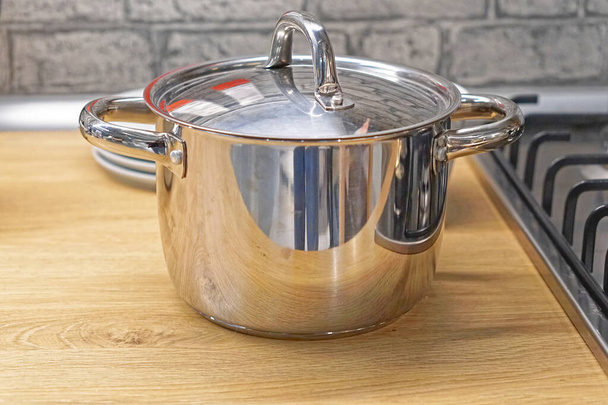 Big stainless steel pot with lid at kitchen countertop - Photo, Image