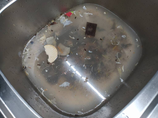 Dirty dishes in the kitchen sink clogged. Complete mess. - Photo, Image