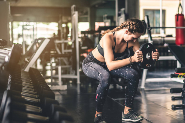 Cinematic tone of young attractive fitness woman exercise with machine in gym. Healthy, workout and diet life style concept.  - Fotografie, Obrázek