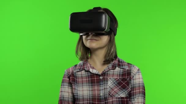 Woman using VR headset helmet to play game, dance. Watching virtual reality 3d video. Chroma key - Footage, Video