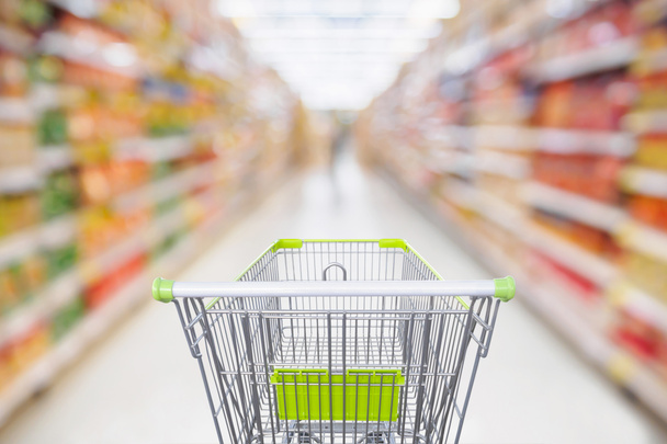 Supermarket aisle with empty shopping cart at grocery store retail business concept - Photo, Image