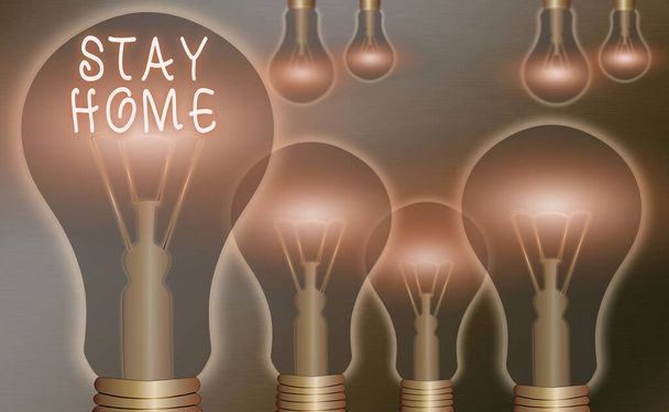 Text sign showing Stay Home. Conceptual photo not go out for an activity and stay inside the house or home Realistic colored vintage light bulbs, idea sign solution thinking concept. - Photo, Image